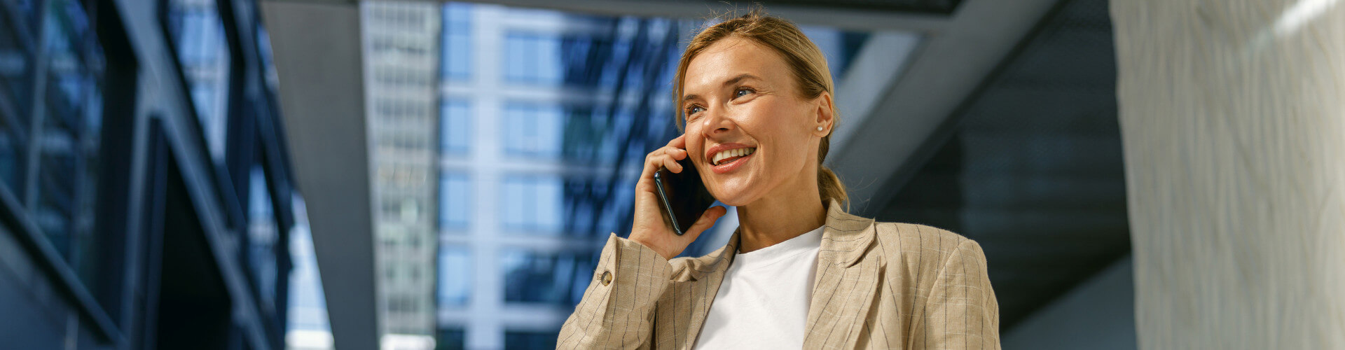 Female professional in a suit making a phone call.