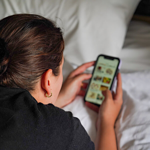 Woman reading accounting newsletters on her phone.