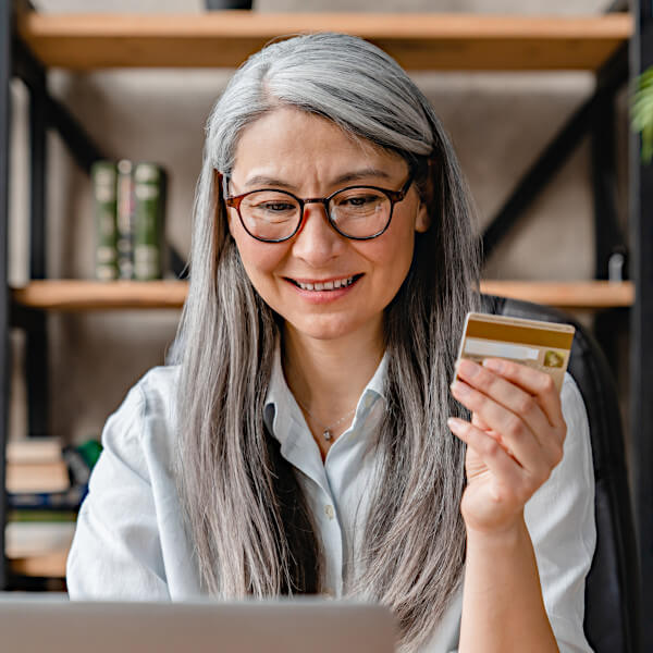 Woman using credit card to pay for digital advertising.